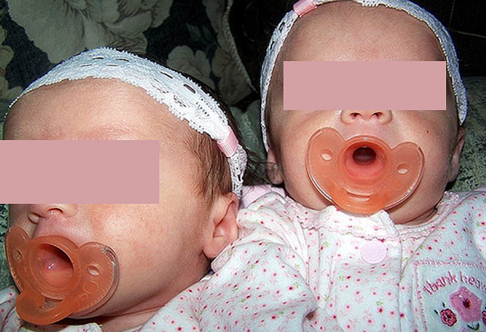 Image of babies with pacifiers